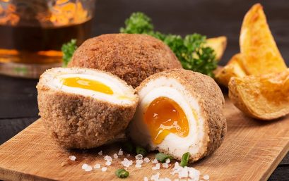 Traditional scotch eggs on a wooden plate
